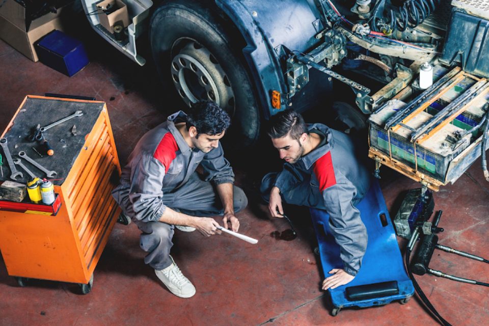 Technicians servicing a truck in the shop